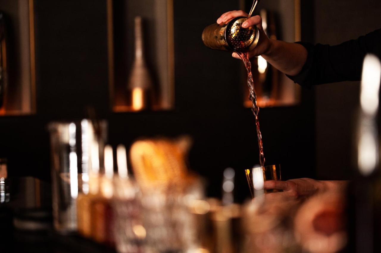 Four Seasons Hotel Riyadh Exterior photo A bartender using a bar spoon to stir a cocktail