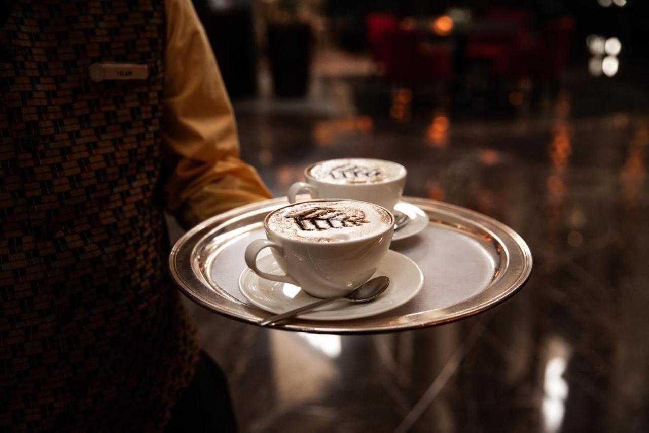 Four Seasons Hotel Riyadh Exterior photo A waiter serving coffee