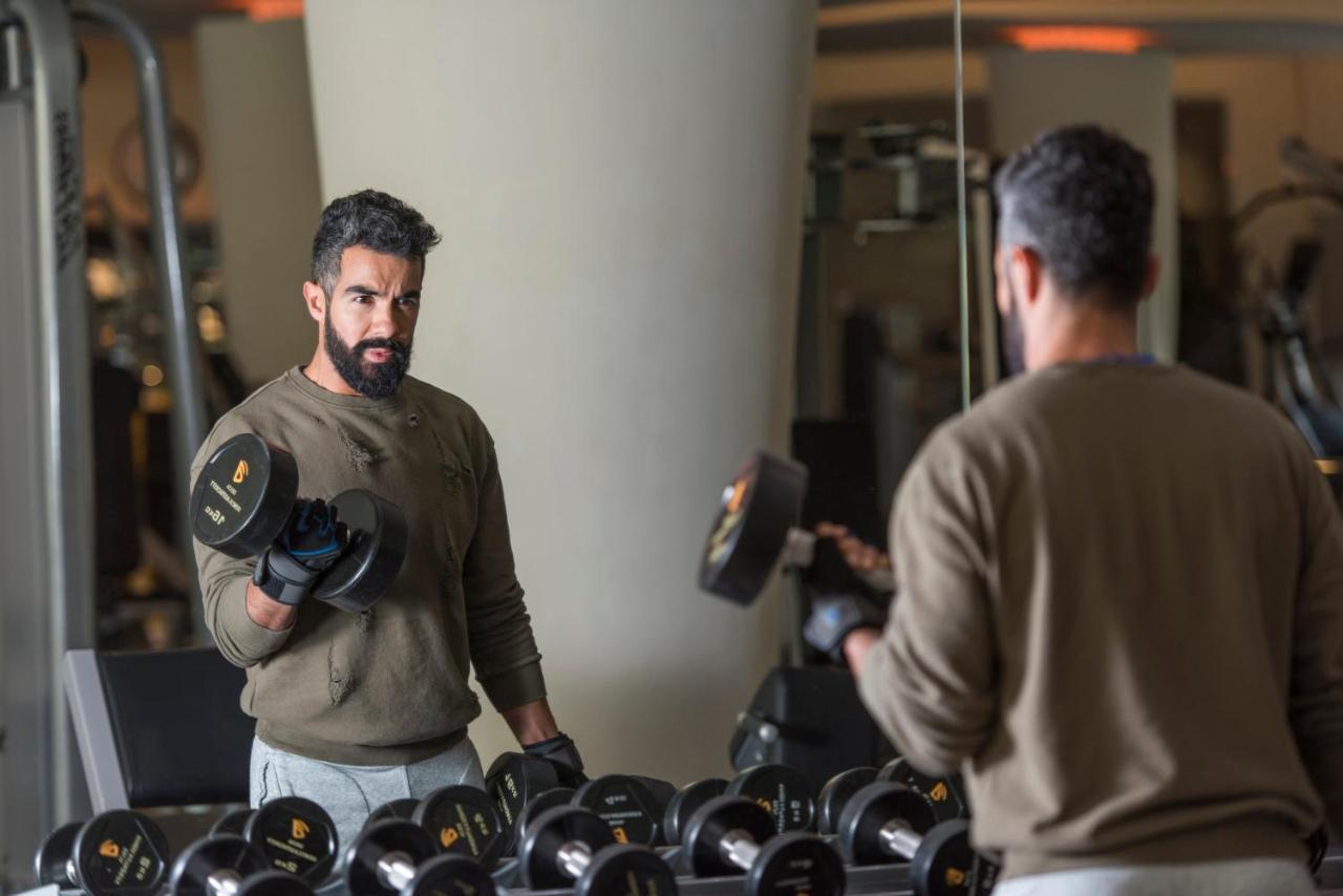 Four Seasons Hotel Riyadh Exterior photo A man lifting weights